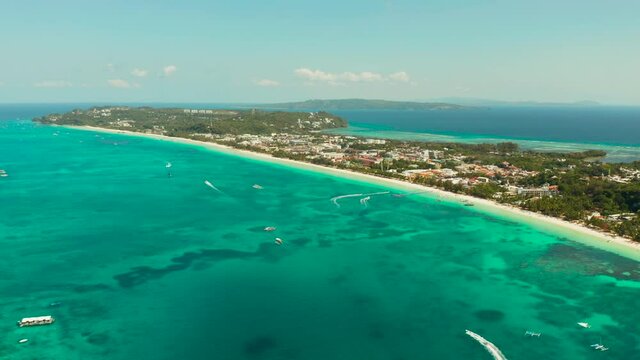 Tropical white sand beach, hotels near the blue lagoon and corall reef. aerial view, Boracay, Philippines. Seascape with beach on tropical island. Summer and travel vacation concept.