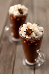Hot chocolate with marshmallow on wooden table with copy space
