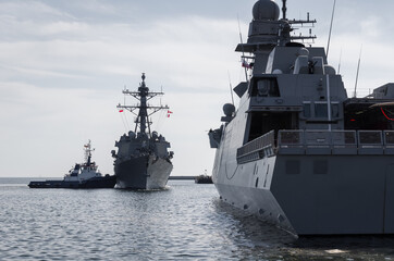 WARSHIPS - An Italian frigate and an American destroyer moored at a seaport wharf 