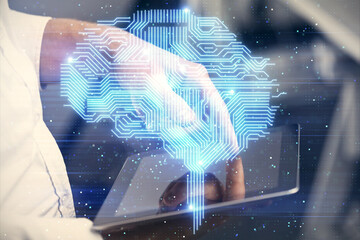 Double exposure of man's hand holding and using a digital device and brain hologram drawing. Data...
