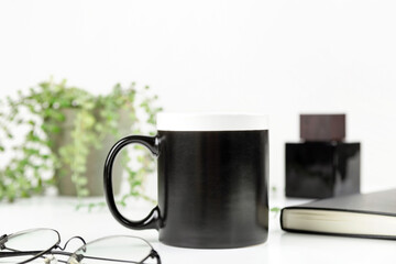 Black dad coffee mug mockup on workplace. Cup mock up for male style design 