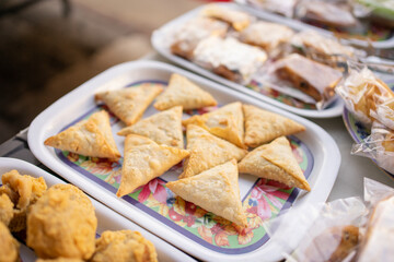 various kinds of fried food, samosas on a serving plate on the table