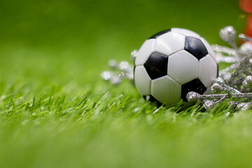 Fototapeta premium Soccer ball is on green grass for Christmas Holiday 