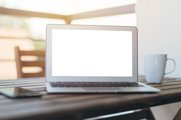 Laptop computer blank empty mock up screen on hotel balcony, working on vacation concept