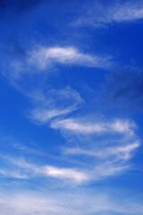 Daytime blue sky with white clouds in the rays of the midday