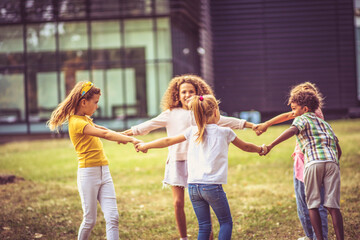 Fototapeta premium Kids dancing in schoolyard.