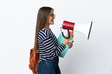 Young student woman isolated on white background shouting through a megaphone