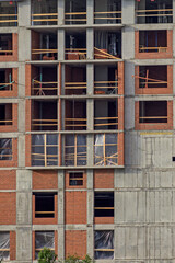 Fragment of the facade of an unfinished multi-storey building