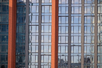 A fragment of the facade of a modern building on a summer evening