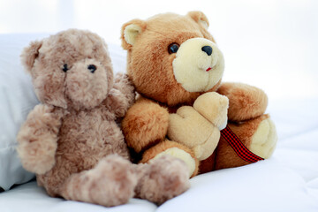 Romantic and delight atmosphere in bedroom set by concept of two brown lovely fluffy teddy bear toys creatively placed nearby as sweet friend acting funny play