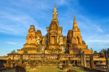 Fototapeta na wymiar Ruins of the ancient Buddhist temple of Wat Mahathat in the light of the evening sun. Old Sukhothai, Thailand