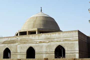 A new mosque under construction against the sunny blue sky, building a new mosque with its big dome...