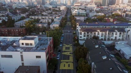Aerial: Black Lives Matter, BLM, painted on the street as a mural. San Francisco, California, USA, 2020 - Powered by Adobe