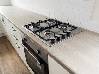 Kitchen counter with newly installed cooker with gas hob burners. Newly renovated house ready for...