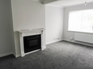 Newly renovated living room with new fireplace and carpets ready for rental or sale depending on...