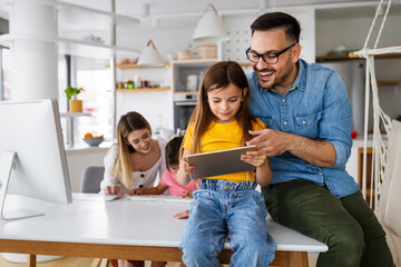 Parents helping to children studying online at home. Lockdown and online school, technology concept.