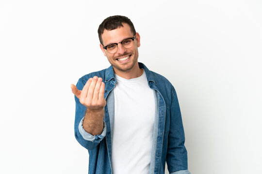 Brazilian man over isolated white background inviting to come with hand. Happy that you came