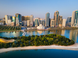 Sharjah aerial view above Al Noor island and mosque and downtown rising above Khalid lake