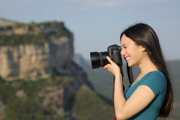Asian woman taking photos with a dslr camera outdoors