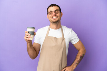 Brazilian restaurant waiter over isolated purple background posing with arms at hip and smiling