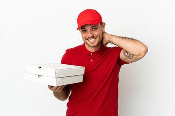 pizza delivery man with work uniform picking up pizza boxes over isolated  white wall laughing