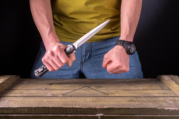 Hold a large knife in your hand. Two hands in the frame. The man attacks with a knife.