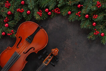 Old violin and fir-tree branches with Christmas decor.  Christmas and New Year's concept. Top view,...