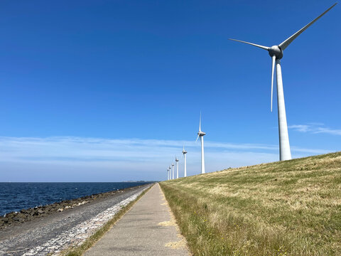 Windmills on a dike at the Noordoostpolder