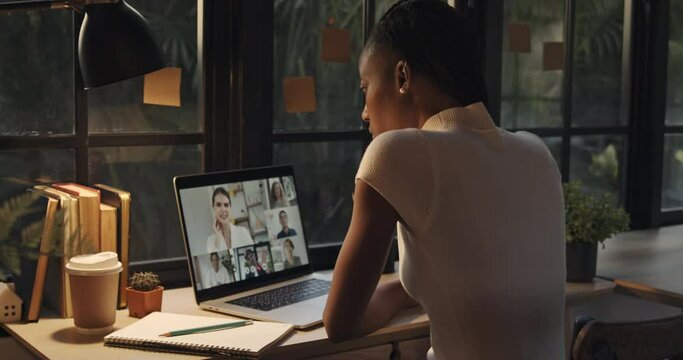 Young African American woman making video call with friends via laptop computer at home, online meeting and distance learning concepts 