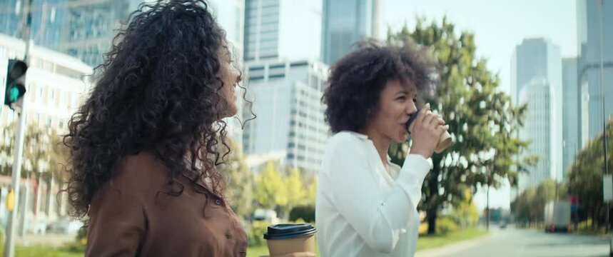 Video Of Two Happy Businesswomen Walking With A Mug Of Coffee. Shot With RED Helium Camera In 8K.