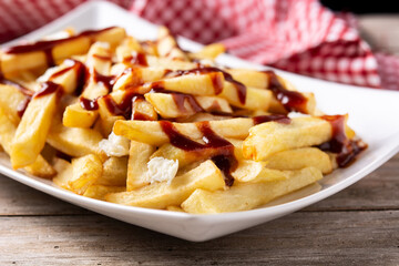 Traditional Canadian Poutine on wooden table
