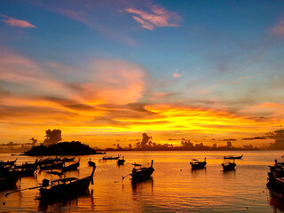 Silhouette Longtail boat on the sea at sunrise, Satun Thailand.