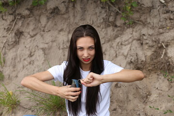 Beautiful woman playing with grenade outside