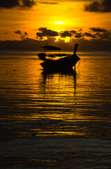 Fototapeta na wymiar Longtail boat on the sea at sunrise in Adang-Ravi Islandsin,Tarutao National Park, Satun Thailand.