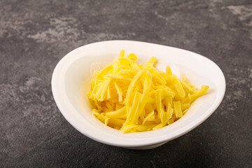 Shredded yellow cheese in the bowl
