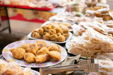 various kinds of traditional Indonesian street food, fried food wrapped in plastic on a serving plate on the table
