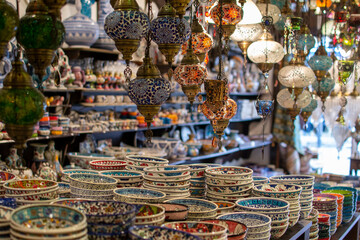 Traditional turkish ceramics (multi-colored plates and lanterns) at orient market. Tourist gift shop with souvenirs.