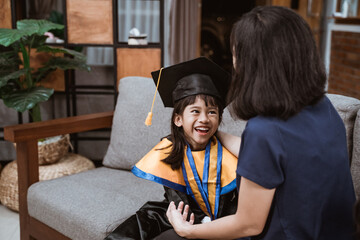 Kindergarten graduation. Asian family and parent on her kid kinder graduate day.