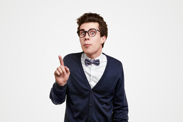 Clever nerdy man pointing up