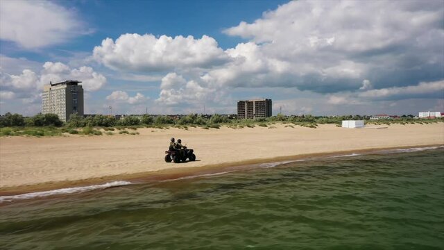 ODESSA, UKRAINE - June 12, 2021: UA customs and border protection. Agents patrol sea shore on the quadrocycle.