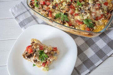 diet vegetable casserole with tomatoes, eggplant and pepper, baked over cheese. Vegetarian casserole with zucchini, mushrooms and cherry tomatoes.