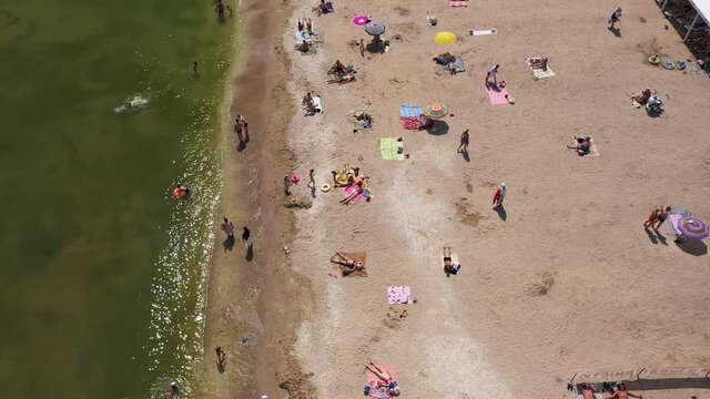 ODESSA, UKRAINE - June 17, 2021: Tourists at the beach in Odessa, sunbathing, playing, swimming, relaxing. Odessa is one of the bigest Ukraine tourist cities.