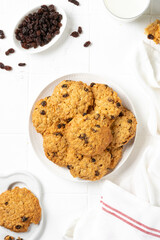 Homemade oatmeal cookies with raisins in a white plate on a light background closeup	