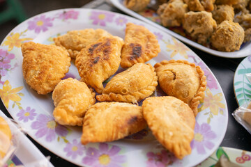 various kinds of traditional Indonesian street food, pastel served on a serving plate on the table