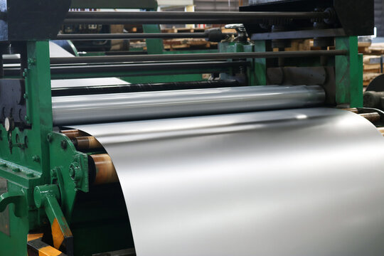 Cold rolled steel sheet on plate rolling machine in production process at factory.