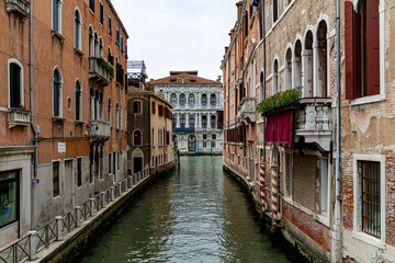 Fototapeta na wymiar A Water Canal (so-called Riva) in Venice, Italy. These waterways are the main means of transport in the city