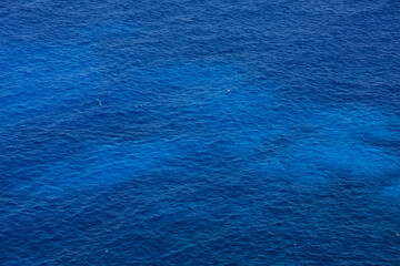 Fototapeta na wymiar Blue sea water background with small waves
