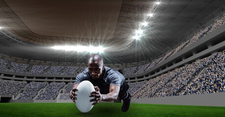 Composition of male rugby player catching ball at stadium