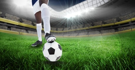 Composition of male football player playing football at stadium - Powered by Adobe
