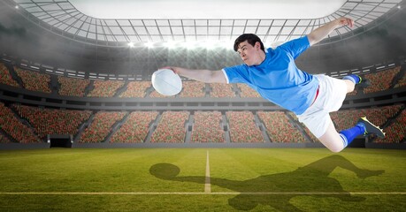 Composition of male rugby player holding rugby ball at stadium